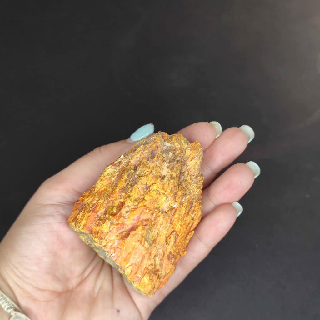 Iranian Realgar and orpiment, also known as red arsenic, weigh 350 grams and measure 7×6×5 centimeters. These stones are treasured for their beauty and metaphysical properties and are sourced from the Zarshouran gold mine in Takab. The chemical formula for these minerals is As4S4. Their striking orange and golden colors create a dazzling appearance.