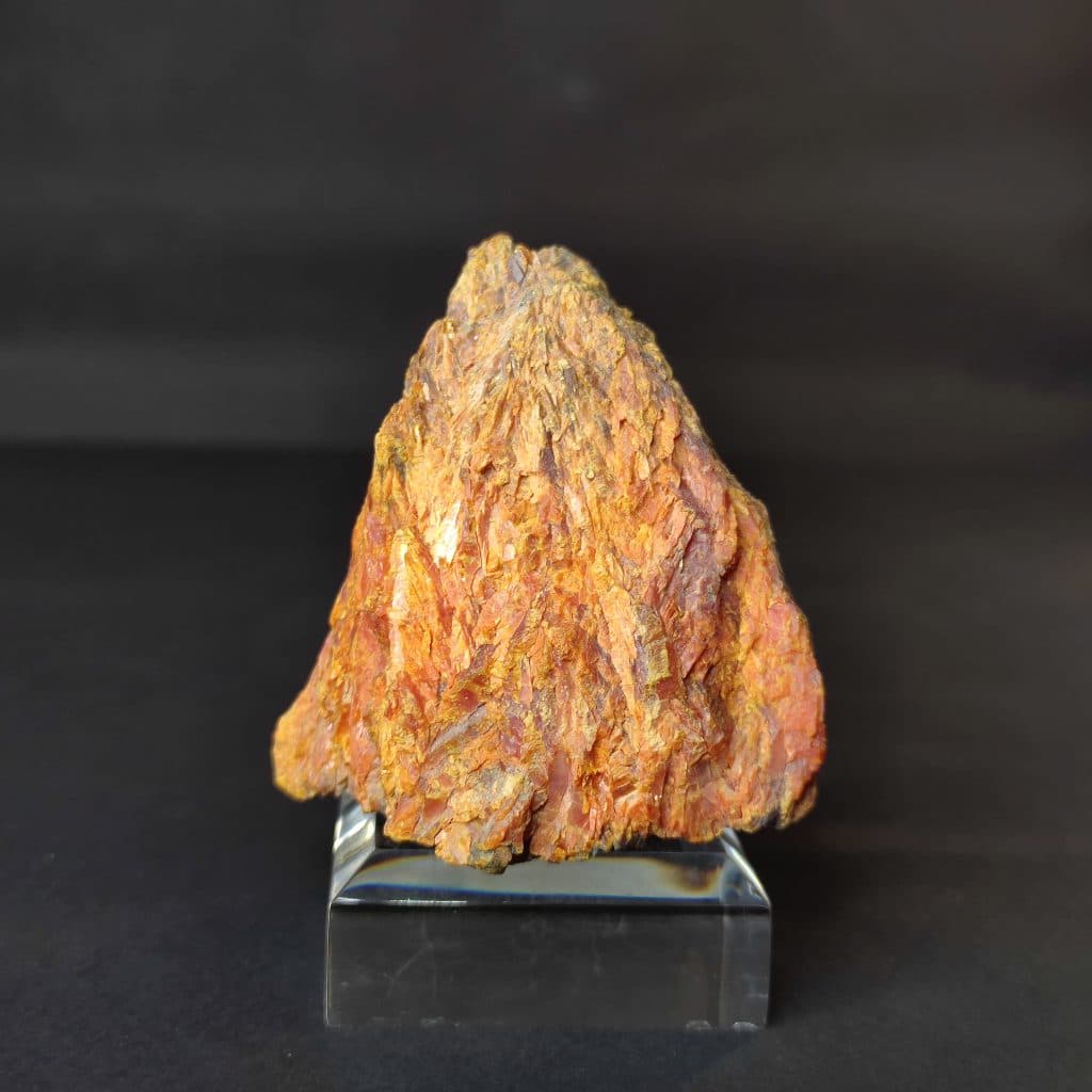 Iranian Realgar and orpiment, also known as red arsenic, weigh 350 grams and measure 7×6×5 centimeters. These stones are treasured for their beauty and metaphysical properties and are sourced from the Zarshouran gold mine in Takab. The chemical formula for these minerals is As4S4. Their striking orange and golden colors create a dazzling appearance.